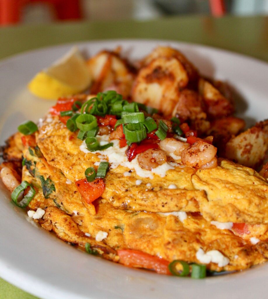 New Year brunch special Shrimp Omelet with home style pototoes on a plate.