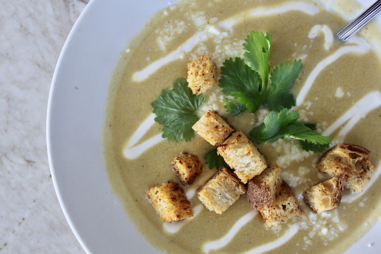 Bowl of Elote Bisque with Tajin croutons.